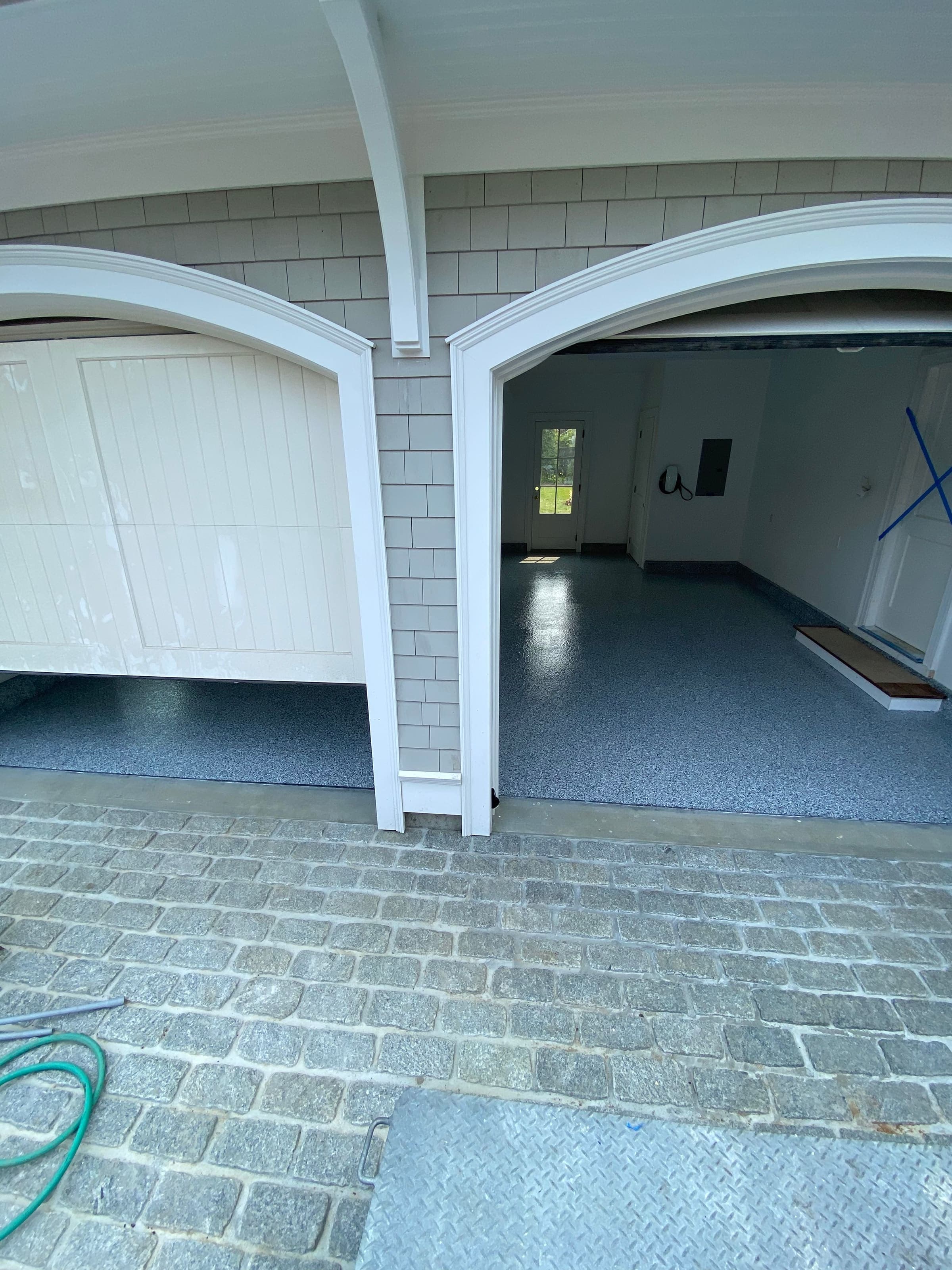 Carriage house garage bay with flake floor