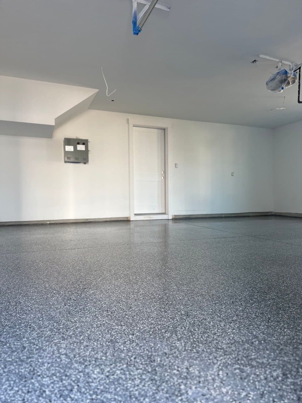 Finished lower-level room with flake floor