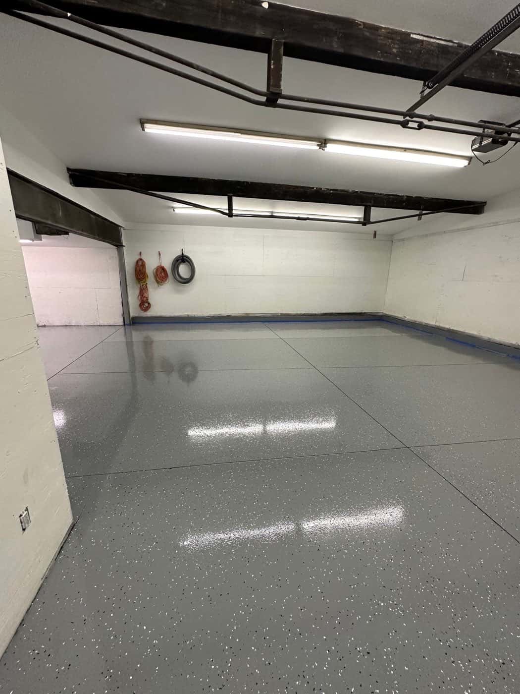 Two-car garage in Maine with a freshly installed gray full-flake epoxy floor