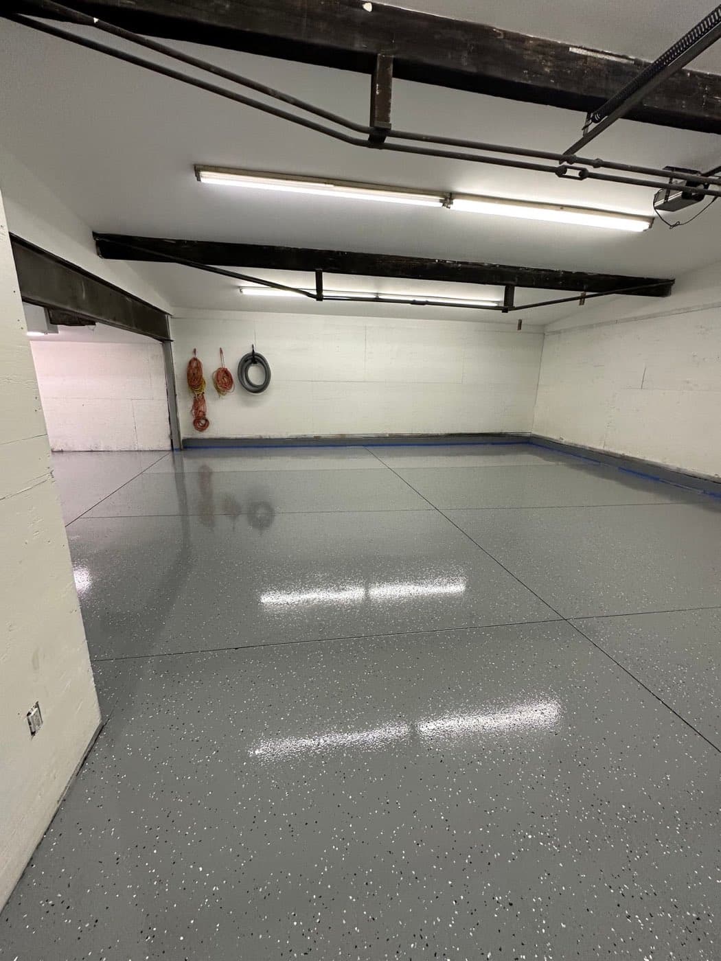 Two-car garage with gray flake epoxy floor