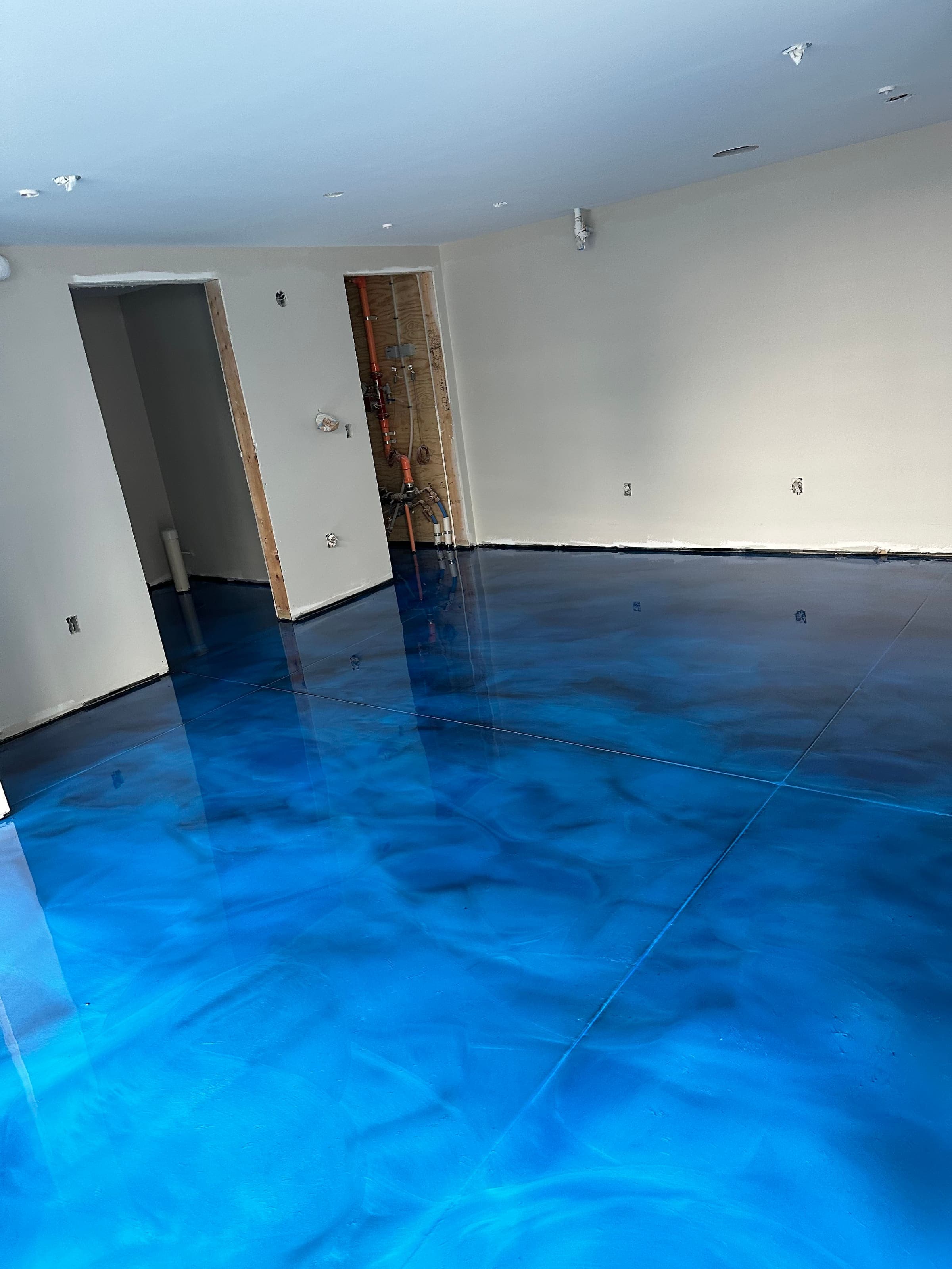 Deep blue metallic epoxy floor with swirled pigment
