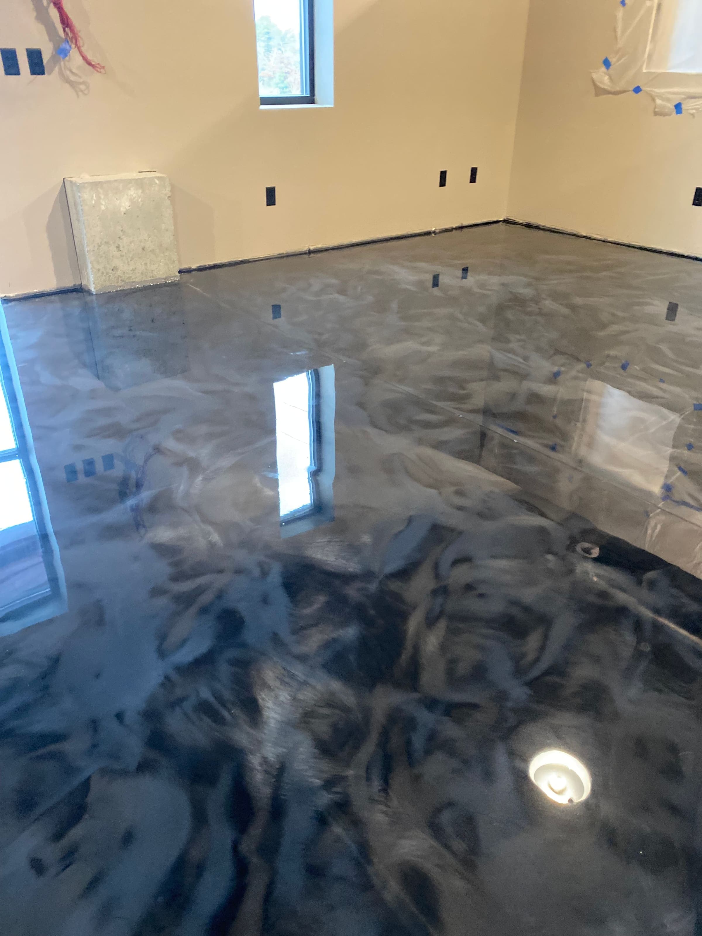 Dark metallic epoxy floor with swirling pattern