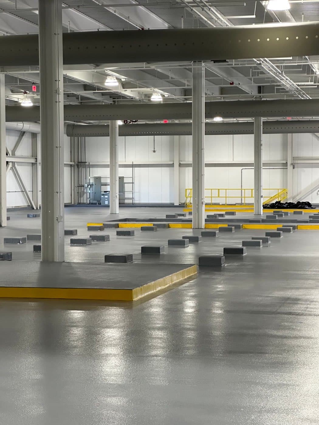 Coated warehouse floor between columns