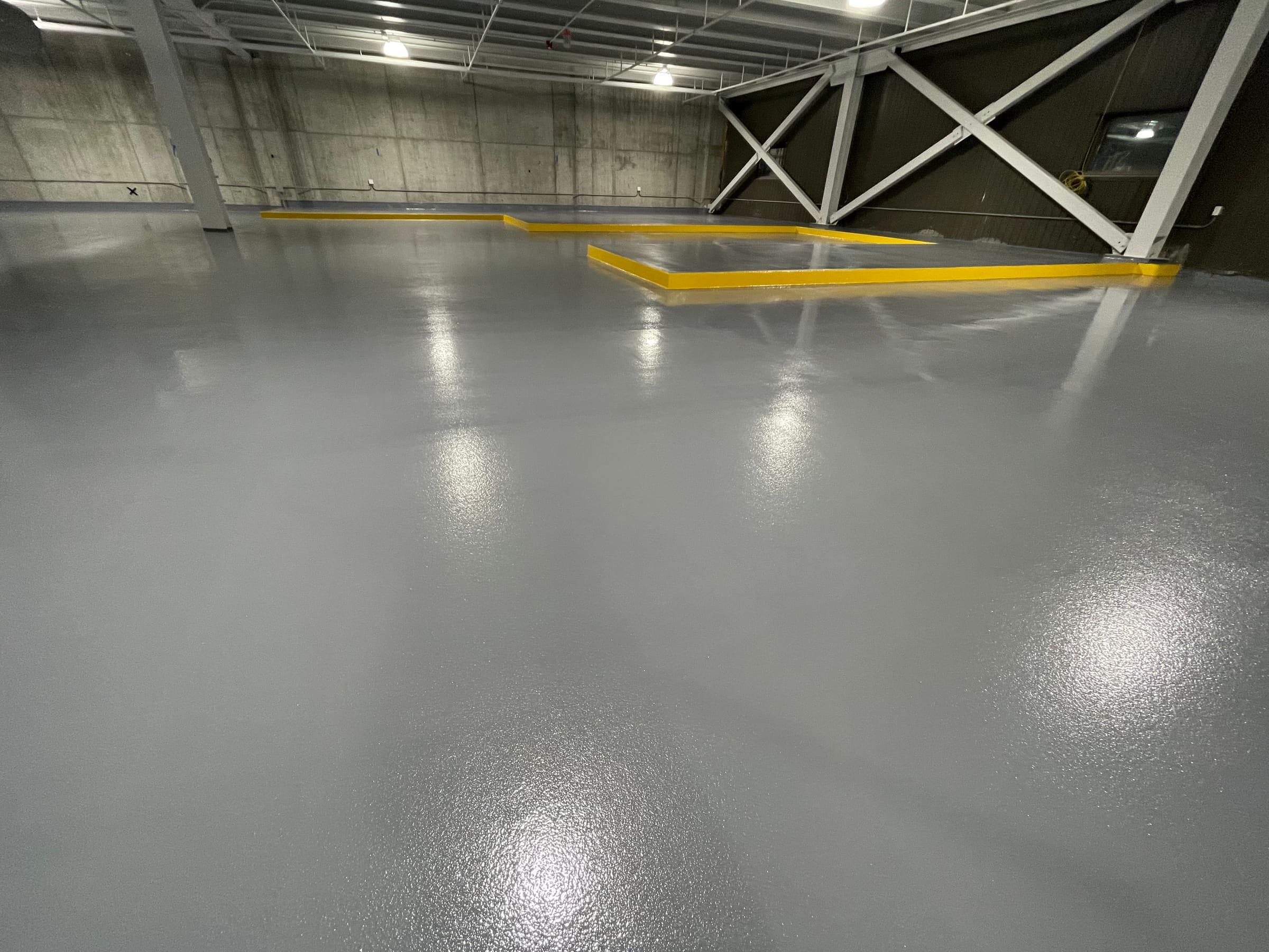 Coated warehouse floor with yellow safety striping